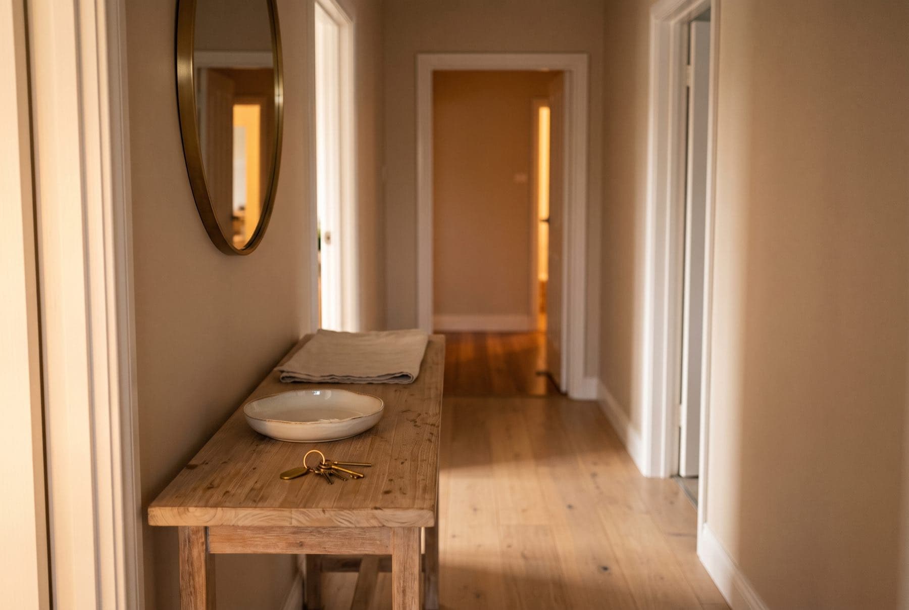 A hallway table in the evening with a set of house keys resting on it